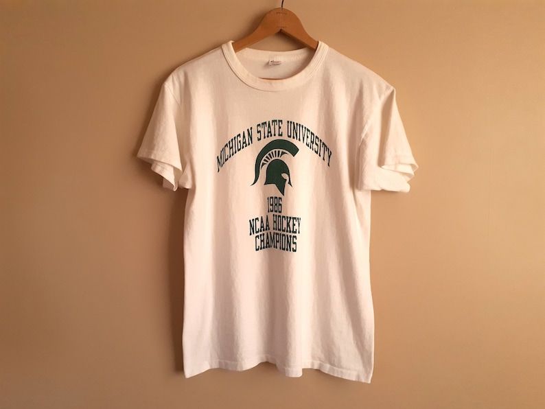 Vintage 1986 Michigan State University Ncaa Hockey Champions White Crew Neck T Shirt Champion Brand Arge Made In Usa Nice Quality